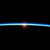 thin_line_of_earths_atmosphere_and_the_setting_sun
