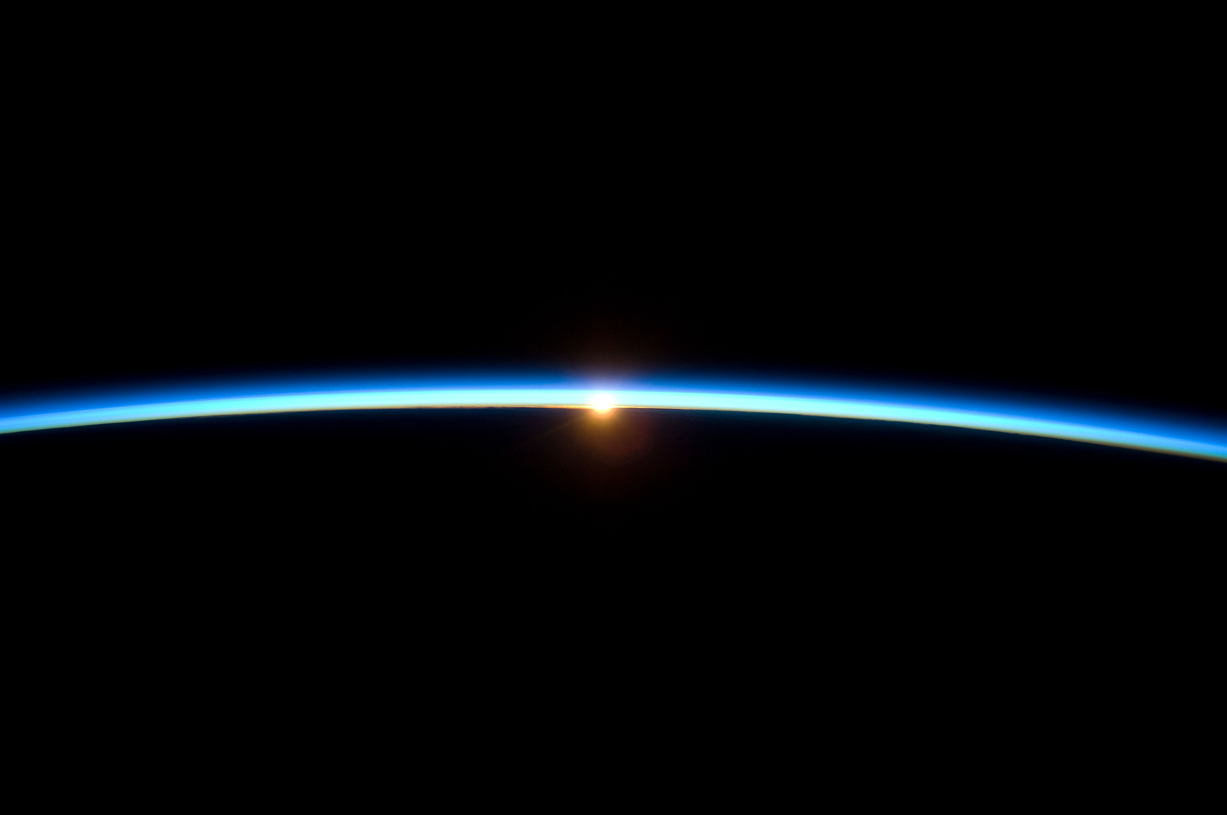 thin_line_of_earths_atmosphere_and_the_setting_sun
