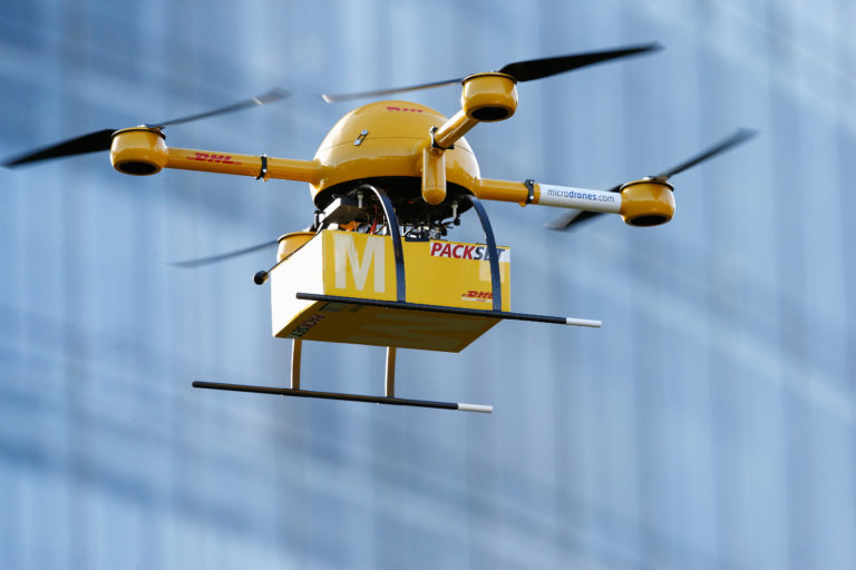 bonn-germany-december-09-a-quadcopter-drone-arrives-with-a-small-delivery-at-deutsche-post-head