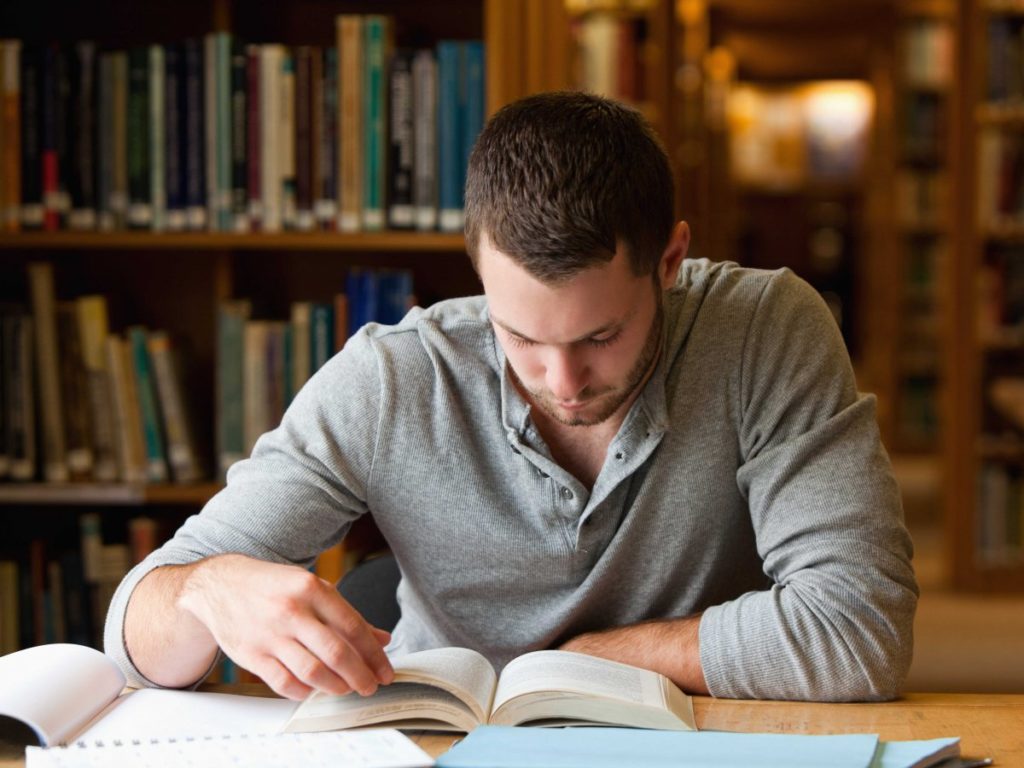 man-studying-at-the-library