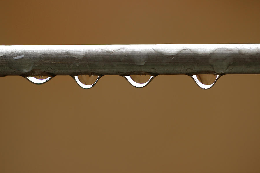four-water-droplets-on-metal-pipe-prakash-ghai